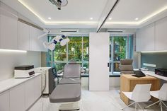 an office with white cabinets and gray chairs