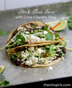 two black bean tacos with lime cilantro slaw on a baking sheet