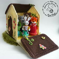 there is a crocheted house with animals in it