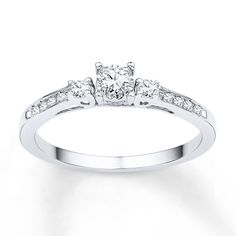 a diamond ring with three stones on the side