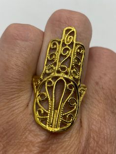 Huge Hand of Fatima for protection Lovely polished brass has the look of antique gold Size 7.75 All rings are shipped in a nice gift box. Check out our over a THOUSAND great reviews Engraving is $4 per letter and is not always perfect depending on the piece. It can take a few days if the jeweler is busy. This is payable to Paypal Judithsltd@gmail.com Gold-tone Brass Rings For Gifts, Gold Filigree Open Ring Gift, Vintage Gold Metal Rings, Gold Filigree Open Ring For Gifts, Ornate Gold Filigree Ring For Ceremonies, Gold Brass Rings As Gifts, Symbolic Gold Rings As Gift, Adjustable Gold Filigree Rings, Gold Vintage Filigree Ring For Ceremonial Occasions