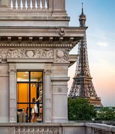 the eiffel tower is in the background as people are walking up and down the stairs