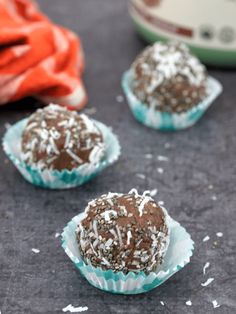 three chocolate truffles with coconut sprinkles on top