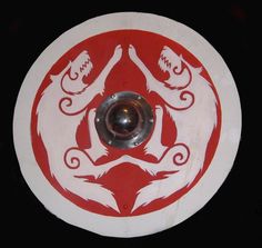 a red and white disk with two hands holding each other in the center, on a black background