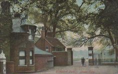 an old photo of a man walking down the street in front of a house with trees