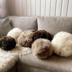 four stuffed animals sitting on top of a couch