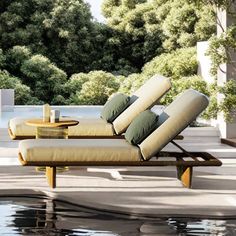 a lounge chair sitting next to a pool with trees in the backgroung