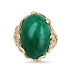 This impressive solitaire ring features a stunning centerpiece in the form of a huge 19-carat oval cabochon cut emerald from Colombia, prized for producing some of the world's most beautiful emeralds. The emerald displays a rich, dark green color that is truly captivating. The emerald is securely set in a unique 14k gold nugget style setting, with nugget prongs that add to the rugged, organic feel of the design. The result is a striking and unforgettable piece of jewelry that is sure to turn heads. Setting Style: Prong-Solitaire  Setting Material: 14K Yellow Gold Setting Weight: 11.0 Grams Main Stone: Emerald Cut: Cabochon Shape: Oval Weight: 19.0-Carats Clarity: Translucent  Color: Green Luster: Very Good Treatments: Natural, Oiling Origin: Colombia Estimated Retail Value: $14,590.00 USD Emerald Cabochon, Emerald Gem, Dark Green Color, 80th Birthday Gifts, Tiny Bow, Solitaire Setting, Gold Nugget, Ladies Ring, Ring Emerald