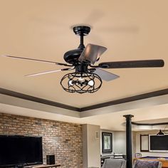 a living room with a ceiling fan, couches and a flat screen tv in it