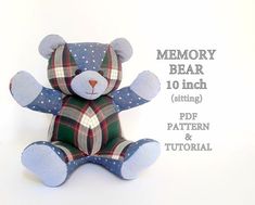 a blue teddy bear sitting on top of a white background with the words memory bear written below it