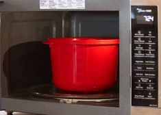 a red container is in the microwave door