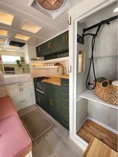 a kitchen with green cabinets and white walls