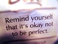 a sign that says, remind yourself that it's okay not to be perfect