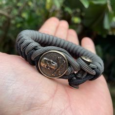 The Pirate flag with skull and crossbone on a dual colored bracelet. Only thing missing is the bottle of rum. Kruger original brass bead in high detail on a 550 black paracord bracelet with toggle closure Limited availability Default colors are dual gray and black. Other colored cords on request Pirate Bracelet, Pirate Flag, The Pirate, Paracord Bracelet, Paracord Bracelets, Colorful Bracelets, Braided Bracelets, Paracord, Mens Bracelet