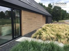 an outside view of a building with grass and bushes