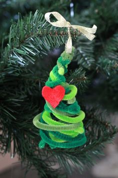 a green christmas tree ornament with a red heart on it