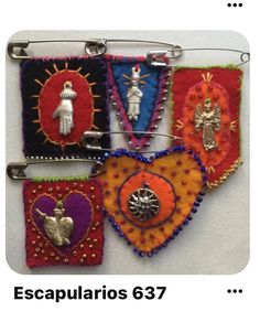 four different colored pieces of cloth hanging on a metal hook with the words escapularios 637 written below them