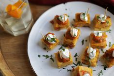 small appetizers are arranged on a plate with toothpicks and garnishes