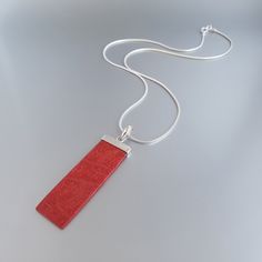 Mens silver chain pendant necklace Red Coral gemstone, Handmade jewelry for men, Unique gifts for men Gnatus all-stone Pendant with natural red Coral and sterling silver hook. The unique long rectangle shape and the natural red/orange color, adds a unique mat spark and gives a modern touch to this pendant. It is thoughtfully set into 925 Sterling silver and a 10mm hook is placed on the upper part of the pendant for perfect balance. Modern design for Men and perfect gift for him. The Pendant feat Modern Red Necklace For Gift, Modern Red Necklace Perfect As A Gift, Minimalist Red Pendant Necklace, Red Minimalist Pendant Necklace, Handmade Red Necklace With Rectangular Pendant, Mens Pendant Necklace, Silver Chain Pendant, Mens Necklace Pendant, Silver Chain For Men