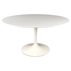 a white table with an oval base on a white background in the shape of a tulip