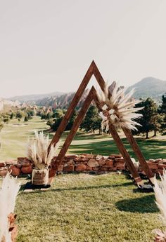 an outdoor ceremony setup with pamolite and feathers on display in the foreground