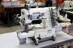 a sewing machine sitting on top of a white table