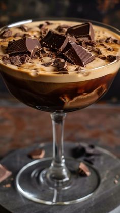 a dessert in a glass with chocolate on top