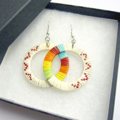 two pairs of earrings in a box with the same color and pattern on each earring