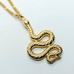 Gold Snake pendant, snake necklace , snake chain necklace, Snake jewelry, Animal necklace, 24k gold filled necklace, bohemian necklace gold Brass 24k plated snake pendant with Figaro stainless steel chain Will ship next working day Silver available here https://www.etsy.com/listing/925133055/snake-ring-silver-ring-statement-ring Spiritual Gold Snake Necklace, Brass Snake-shaped Necklace For Gifts, Tarnish Resistant Snake Chain Charm Necklace, Gold Snake Necklace With Clavicle Chain, Snake Shape Gold Chain Necklace Gift, Gold Snake Shape Chain Necklace Gift, Gold Snake Necklace With Adjustable Chain, Gold Plated Snake Necklace, Spiritual Gold Snake Chain Necklace