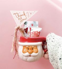 a person holding a christmas mug in their hand