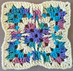 a crocheted square with multicolored flowers on it