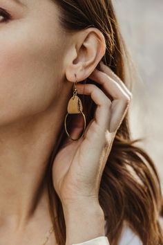 These lightweight, handcrafted hoop earrings are the perfect touch for any fall look. Simple yet elegant, they pair beautifully with both casual and formal outfits. An ethical choice for the modern woman who values style with purpose. #MinimalistJewelry #FallEarrings #SlowFashion #JoffaJewelry #EthicalFashion Artisan Round Brass Earrings, Artisan Brass Hoop Earrings, Effortless Style Fall, Luxury Brass Hoop Earrings, Chic Gold-tone Brass Hoop Earrings, Gold-tone Brass Hoop Earrings With Polished Finish, Best Travel Accessories, Brass Hoops, Formal Outfits