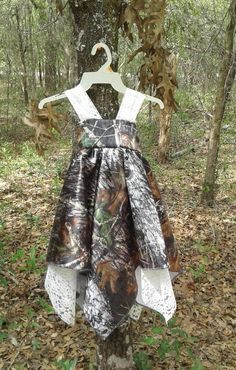 a dress hanging on a tree in the woods