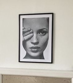 a black and white photo hanging on the wall above a fireplace