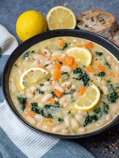 a bowl of white bean soup with lemons and bread