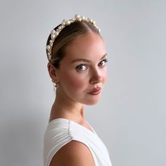 The Allegra Crystal and Pearl Bridal Headband is a versatile and timeless accessory that can be styled in various ways. It can be worn with hair down to keep it off your face, or paired with a half up half down or sleek bun hairstyle. Handcrafted with multi-sized pearls and a touch of Genuine Swarovski Crystals, this wedding headband has become a popular choice for modern brides in recent seasons. Made in our Calgary studio, it features a gold headband wrapped in light gold satin for ultimate co Sleek Bridal Bun, Bun With Headband, Updo Sleek, Sleek Bun Hairstyles, Pearl Headpiece Wedding, Elegant Wedding Jewelry, Crystal Headpiece Wedding, Bridal Bun, Pearl Bridal Headband