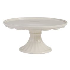 a white cake plate sitting on top of a table