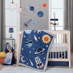 a baby crib bedding set with space theme