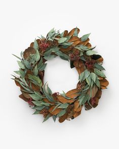 a wreath made out of leaves and berries