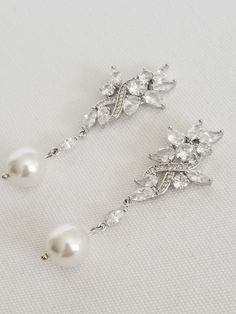 "Gorgeous sparkly cubic zirconia wedding earrings for the bride. Handcrafted with Swarovski pearls and high quality cubic zirconias. For pierced ears only. I do have other types of pearls available such as freshwater pearls and shell pearls that are in different shapes & sizes. Please contact for other options. ♥ SIZE: 2 1/8\" long x 3/4\" wide ♥ COLORS: Silver, Gold, Rose Gold ♥ PRODUCTION TIME: Ready to ship out in 1-2 business days ♥ IMPORTANT: Please be sure to read my policy section for Diamond White Dangle Pearl Earrings For Weddings, Silver Pearl Diamond Earrings For Wedding, White Bridal Earrings With Pearl Charm And Cubic Zirconia, Wedding Crystal Earrings With Pearl Drop, Pearl White Bridal Earrings With Pearl Drop, Wedding Pearl Drop Crystal Earrings In Cubic Zirconia, Pearl-embellished Cubic Zirconia Drop Earrings, Diamond White Cubic Zirconia Pearl Earrings For Wedding, Cubic Zirconia Pearl Drop Earrings