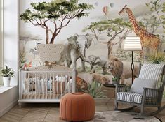 a baby's room with an animal mural on the wall