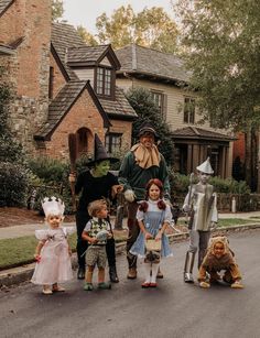 a group of people in costumes standing on the street