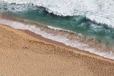 an aerial view of the beach and ocean