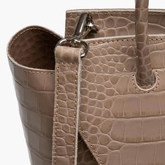 This stylish and effortless medium size bag is handcrafted in Italy with premium c quality crocodile print leather, making it lightweight yet durable. It's easy to clean and maintain, so it'll stay looking as good as new for years to come. With its timeless design and classic look, this tote bag will be a timeless addition to your wardrobe. Whether you're heading out for the day, or going away for the weekend, this midi purse is sure to turn heads wherever you go.