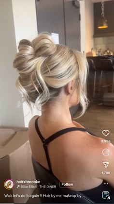 the back of a woman's head with her hair in a low bun