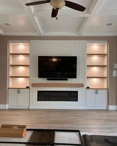 a living room with built in shelves and a flat screen tv