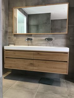 a bathroom vanity with two sinks and a large mirror