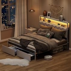 a bedroom with a bed, night stand and window overlooking the city lights at night