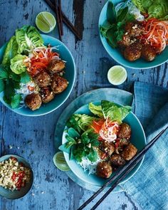 three plates filled with meatballs and veggies next to chopsticks on a table