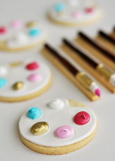 the cookies are decorated with paintbrushes and other things to make them look like they have been painted